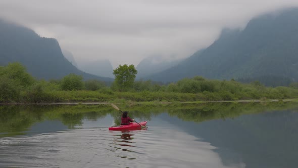 Adventure Caucasian Adult Woman Kayaking in Red Kayak