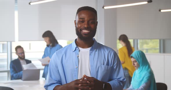 Happy Afroamerican Male Manager Looking at Camera and Talking Having Video Conference