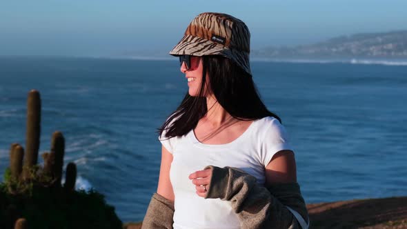 beautiful happiness young woman girl latin portrait with bucket hat on the beach,sunset, pichilemu,