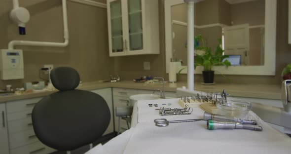 Empty interior of dental clinic with black dental chair and tools