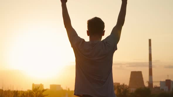 Silhouette of a man practicing yoga on the background of a beautiful sunset. Slow motion