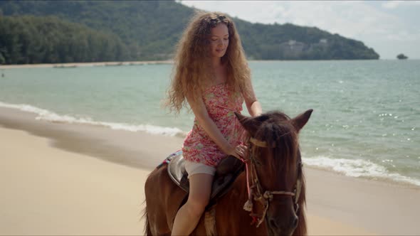 Free Confident Woman Riding Horse on Seaside