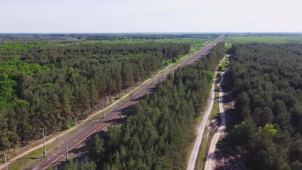 Aerial View of Railroad with Train in Sunny Summer Day in Forest