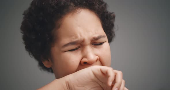 Young African Woman Yawning Tired Covering Mouth with Hand Isolated on Gray Background