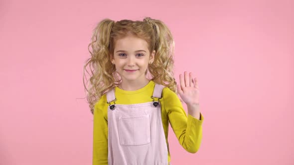 Young Girl Is Waving Hello with Her Hand. Slow Motion