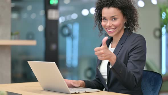 Thumbs Up By African Businesswoman Working on Laptop