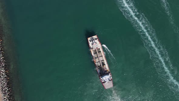 Large ship powering through the waterway causing harmful disturbance to a highly sensitive marine pr