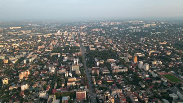 Aerial drone view of Chisinau downtown. Panorama view of multiple buildings, roads with moving cars 
