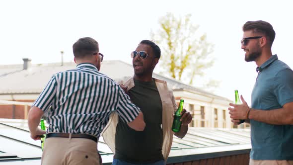 Happy Male Friends Drinking Beer at Rooftop Party