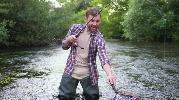 Fisherman with Fishing Rod on the River