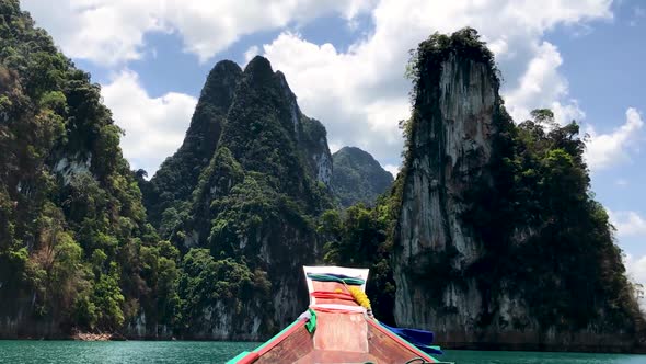 High rocks at Cheow Lan Lake, Thailand, view from long tail boat