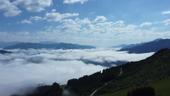 Morning Flight over Beautiful mountains and clouds in the Alps of Austria.