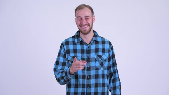 Happy Bearded Hipster Man Laughing and Pointing at Camera