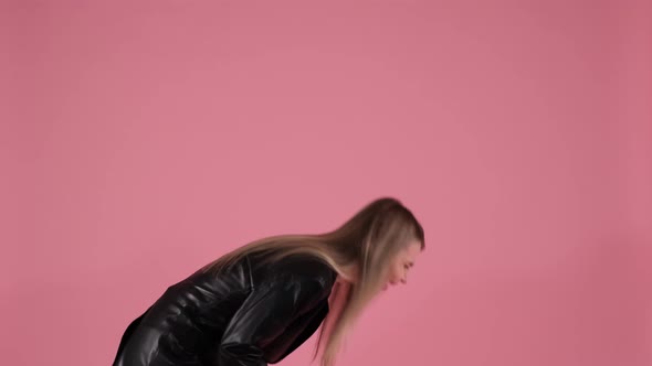 Pretty Woman Laughs to Tears on a Pink Background