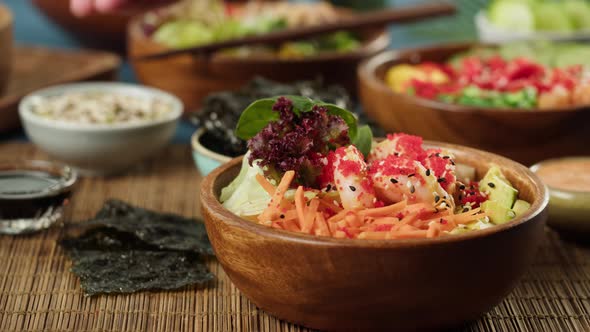 Sprinkling Sesame Seeds on Cooked Poke Bowl Closeup