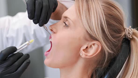 Part of dentist giving woman anesthesia in dentist's clinic