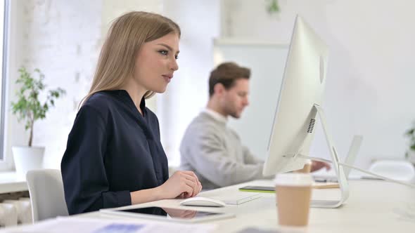 Beautiful Creative Woman Doing Video Chat on Desktop in Office