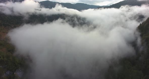 Flying above the clouds in the mountains