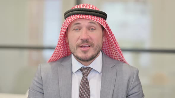 Portrait of Middle Aged Arab Businessman Talking on Online Video Call