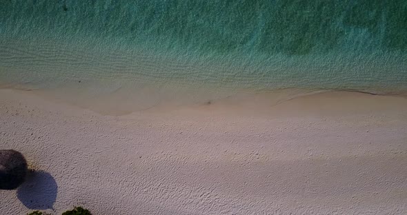 Luxury drone abstract view of a white paradise beach and aqua blue water background in hi res 4K