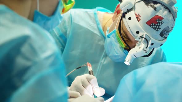 Male surgeon in operation room. Surgeon during operation process in surgery