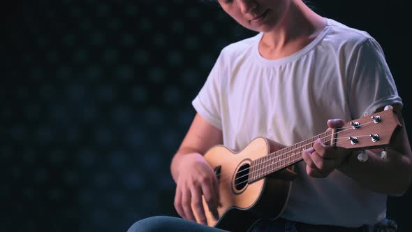 Musician with an Instrument. Little Guitar