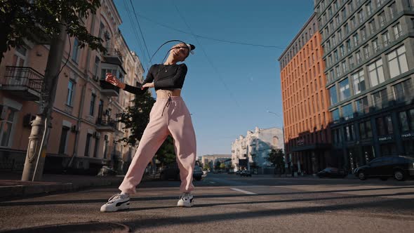 Young Woman Performs Marvellous Dance Against Cars in City