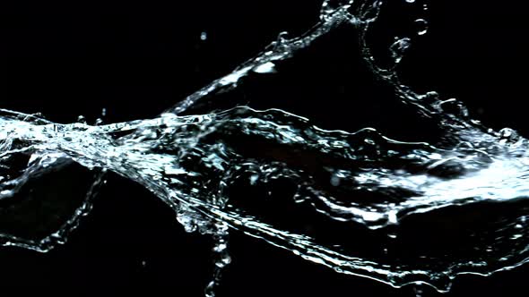 Super Slow Motion Shot of Swirling and Splashing Water Isolated on Black Background at 1000Fps