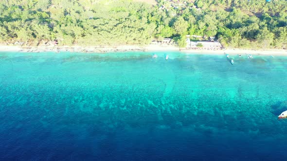 Wide angle aerial island view of a sandy white paradise beach and aqua turquoise water background in