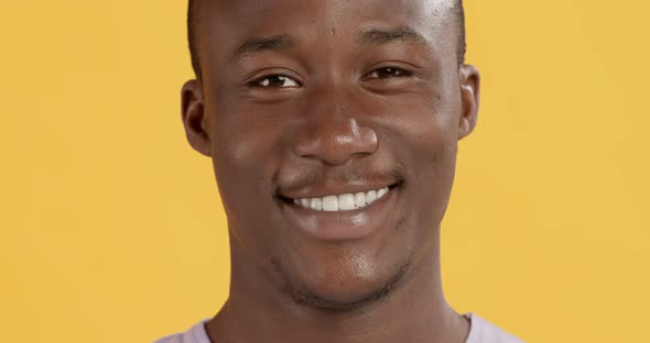 Close Up Portrait of Black Man with Perfect Teeth Smiling at Camera