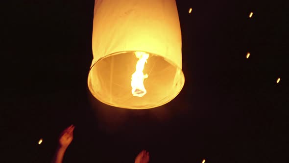 Asian Woman Releasing A Sky Lantern