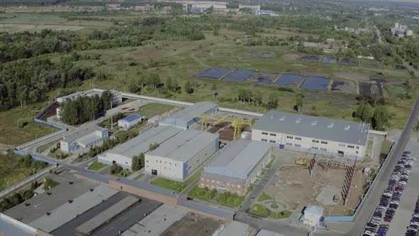 Aerial View Park Production Plant. Manufacturing Area in Field Drone View. Aerial Top Down View