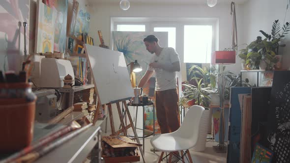 Man Lighting Incense Stick in Art Studio