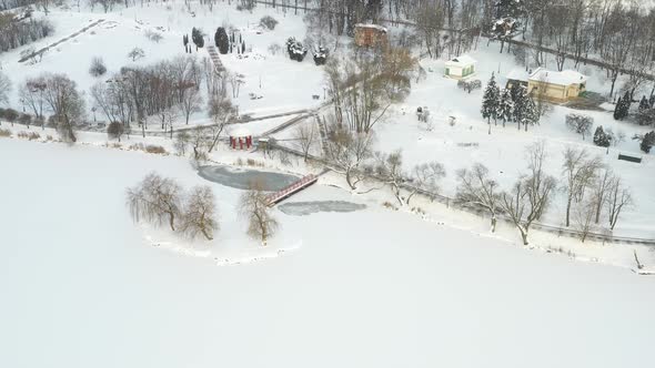 An Island on a Lake with a Bridge in the Winter Loshitsky Park