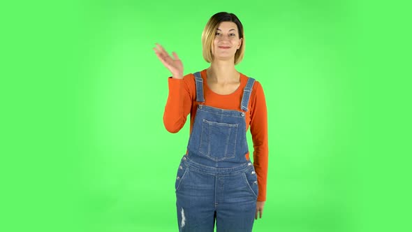 Woman Waving Hand in the Studio. Green Screen