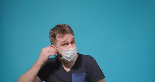 Bearded Guy Takes Off White Disposable Mask Shakes with Joy