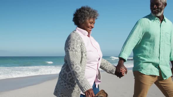 Senior couple walking at the beach