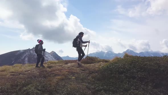 Mom With Child During A Mountain Hike