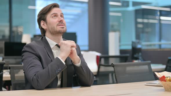 Disappointed Businessman Sitting Tense at Work