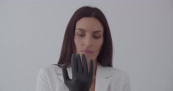 The Beautician Wears Black Gloves For Examination