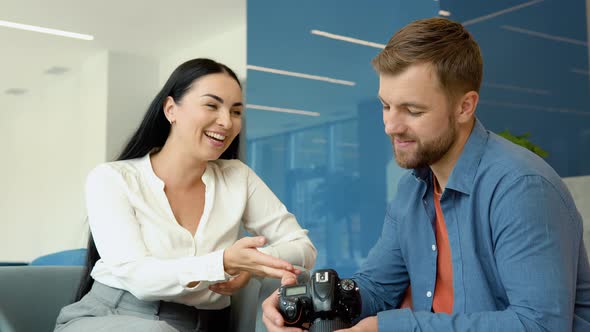 Photographer and Model Watch Photos Sitting in the Business Center