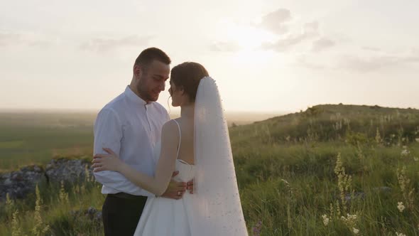 Back Side View of Groom and Bride That Smile and Hug