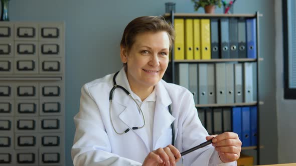 Portrait of a Senior Female Doctor Sitting in Her Office