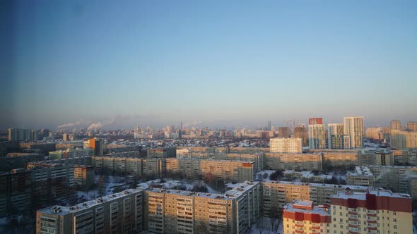 City Pipes Emit Steam Into the Atmosphere Against the City Skyline