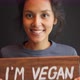 Young Mixed Race Woman Holding Wooden I Am Vegan Sign - VideoHive Item for Sale