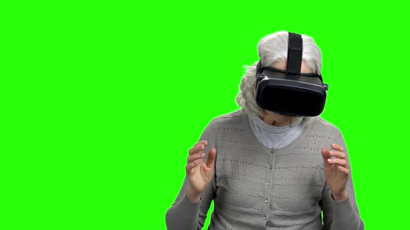 Elderly Woman Wearing Virtual Reality Goggles.