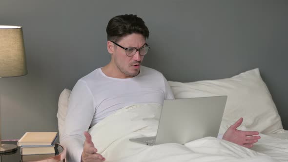 Middle Aged Man with Laptop Having Loss in Bed 