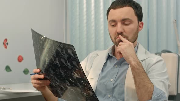 Doctor Examining an X-ray and Say on the Camera