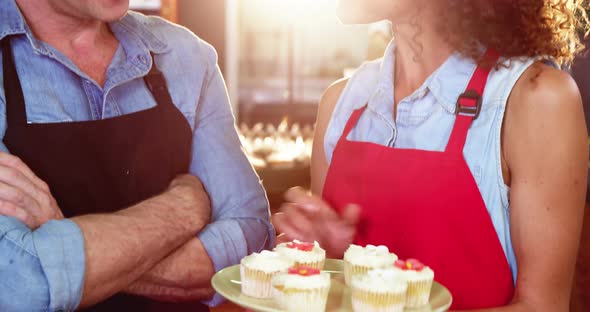 Smiling staff interacting at bakery counter