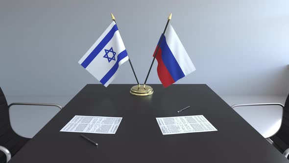 Flags of Israel and Russia on the Table